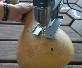 cutting a gourd jack-o'-lantern