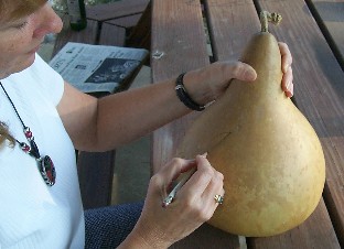 woman crafting a kettle gourd